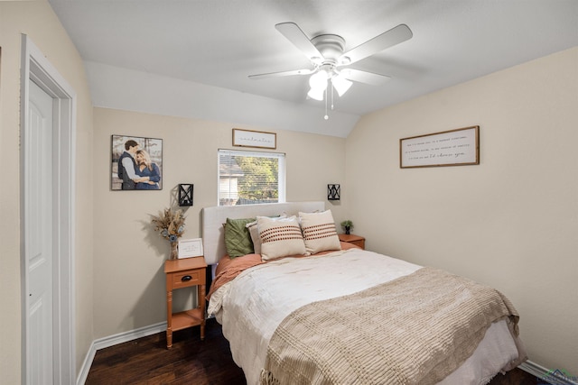 bedroom with ceiling fan, lofted ceiling, and dark wood-type flooring