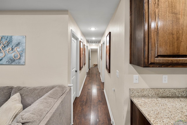 corridor with dark hardwood / wood-style flooring