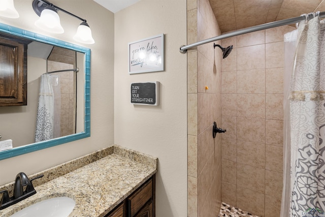 bathroom featuring curtained shower and vanity