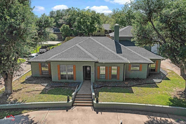1208 Westwood Dr, Henderson, TX 75654 - view of front facade featuring a front yard, brick siding, and roof with shingles