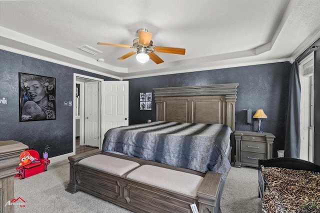 1208 Westwood Dr, Henderson, TX 75654 - bedroom with a ceiling fan, visible vents, a raised ceiling, carpet floors, and a textured wall