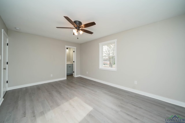 unfurnished bedroom with light wood-type flooring, ensuite bath, and ceiling fan