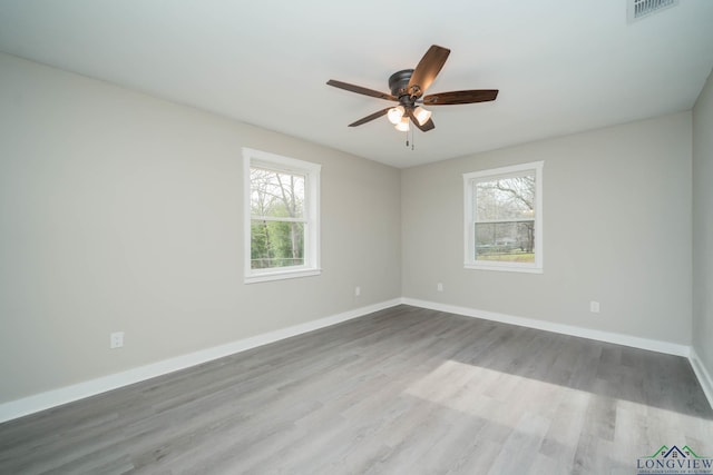 empty room with wood-type flooring and ceiling fan