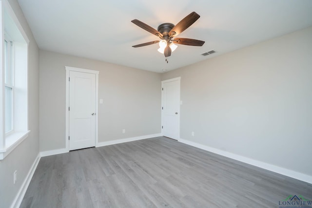 spare room featuring light hardwood / wood-style floors and ceiling fan