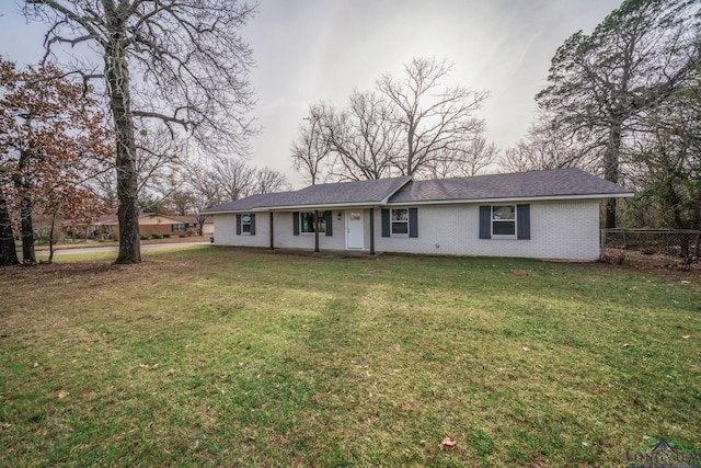 ranch-style home featuring a front yard