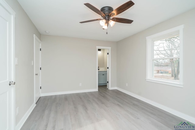 unfurnished bedroom featuring ceiling fan, connected bathroom, and light wood-type flooring