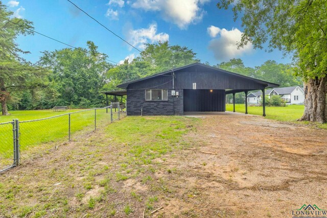 2820 W Upshur Ave, Gladewater, TX 75647 - view of outdoor structure with driveway and a carport