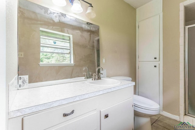 2820 W Upshur Ave, Gladewater, TX 75647 - bathroom featuring toilet, vanity, tile patterned flooring, and a stall shower