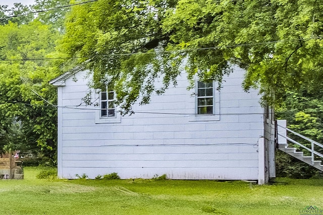 2820 W Upshur Ave, Gladewater, TX 75647 - view of home's exterior featuring stairway and a lawn