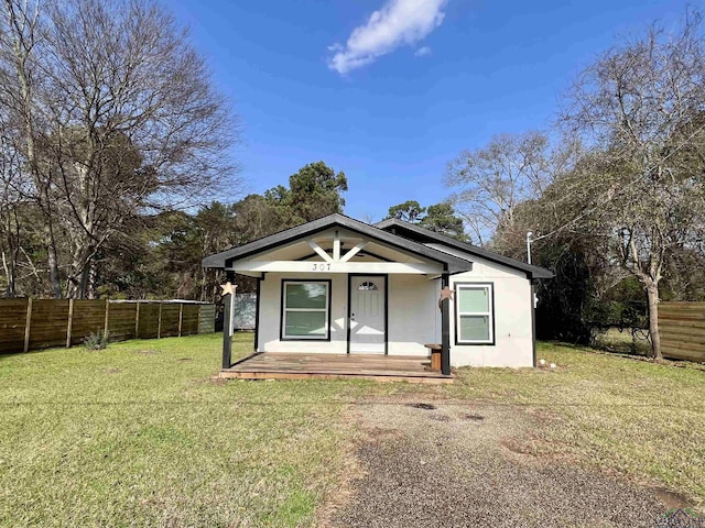 bungalow-style home featuring a porch and a front yard