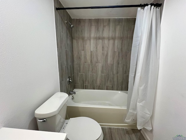 bathroom featuring hardwood / wood-style floors, shower / bath combination with curtain, and toilet