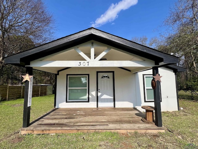 entrance to property with a lawn