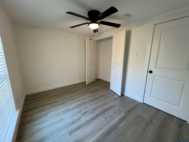 unfurnished bedroom with ceiling fan and light wood-type flooring