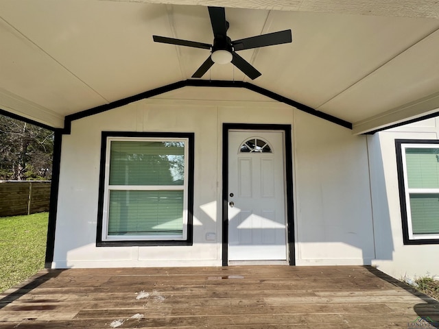 entrance to property featuring ceiling fan and a deck