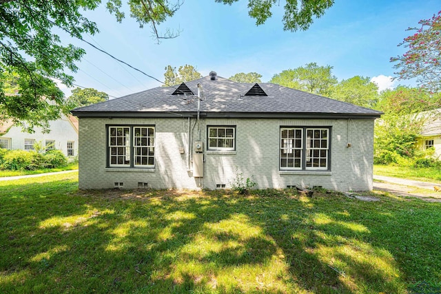 rear view of property with a yard