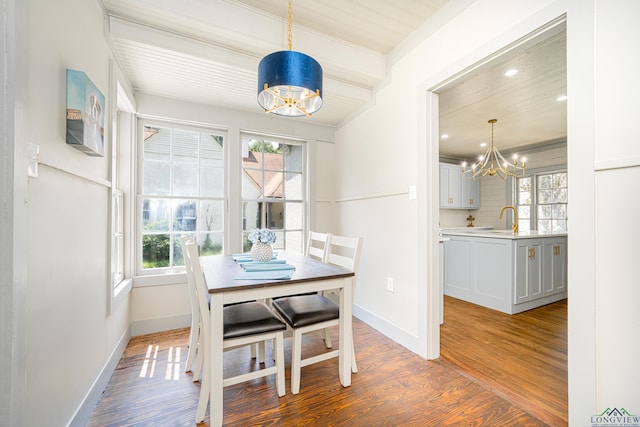 dining area featuring hardwood / wood-style floors, an inviting chandelier, and a healthy amount of sunlight