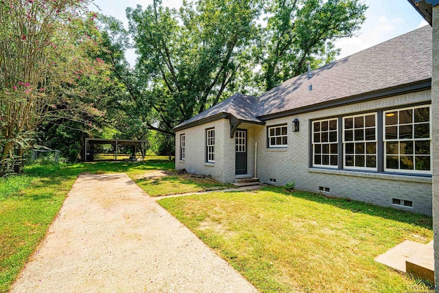 35 Covington Dr, Longview, TX 75602 - view of front of property with a front lawn, a carport, driveway, and entry steps