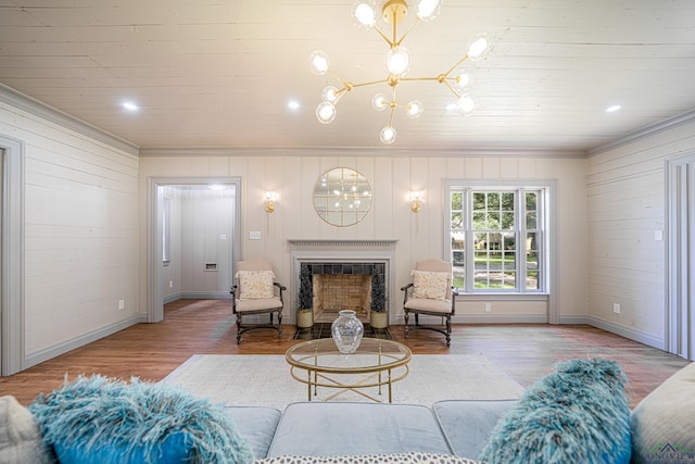 living room featuring a high end fireplace, wood-type flooring, and an inviting chandelier