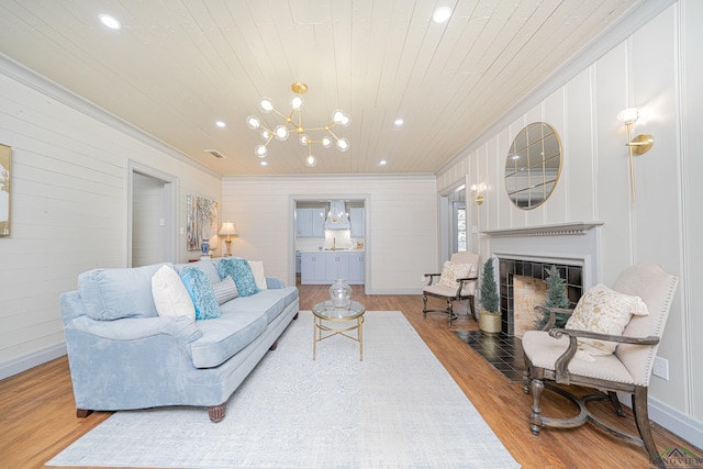 living room featuring a chandelier, hardwood / wood-style flooring, crown molding, and wooden ceiling