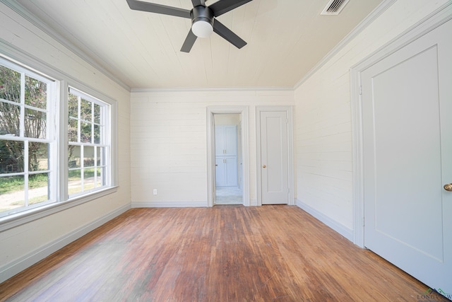 35 Covington Dr, Longview, TX 75602 - unfurnished bedroom with wood finished floors, ornamental molding, wooden ceiling, wooden walls, and ceiling fan