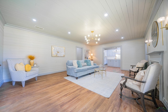 living room featuring light hardwood / wood-style flooring, a notable chandelier, and wood ceiling