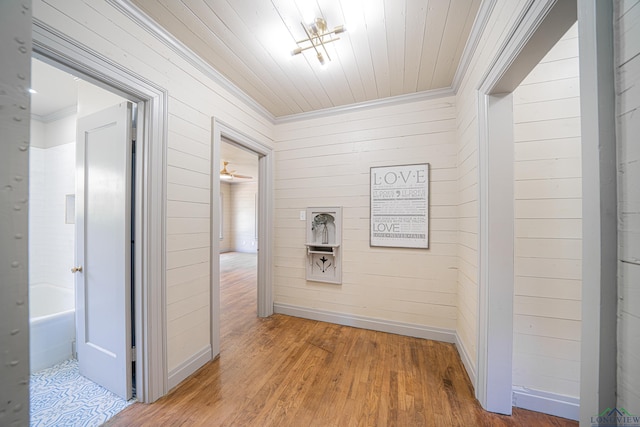 corridor featuring hardwood / wood-style floors, wooden walls, and wood ceiling