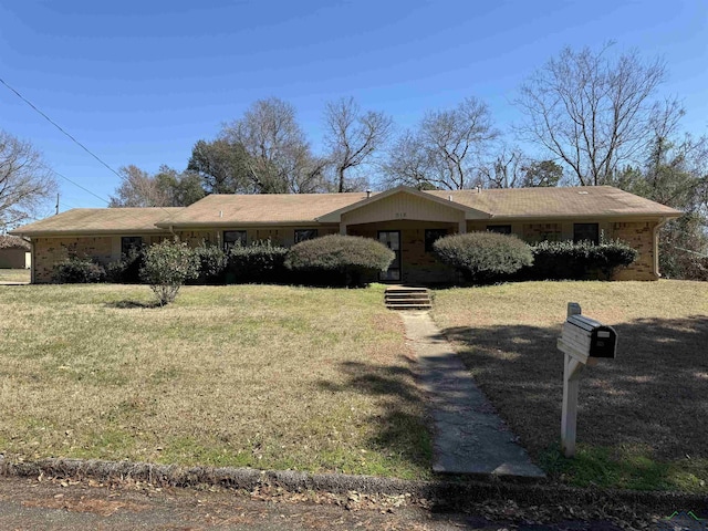 single story home featuring a front lawn and brick siding