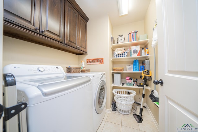 washroom with cabinets, independent washer and dryer, and light tile patterned floors