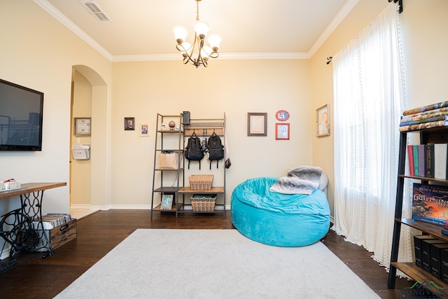 living area featuring ornamental molding, dark hardwood / wood-style floors, and a notable chandelier