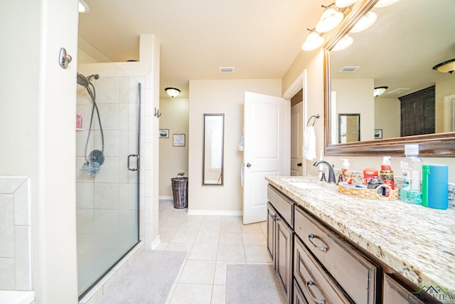 bathroom with tile patterned floors, vanity, and walk in shower