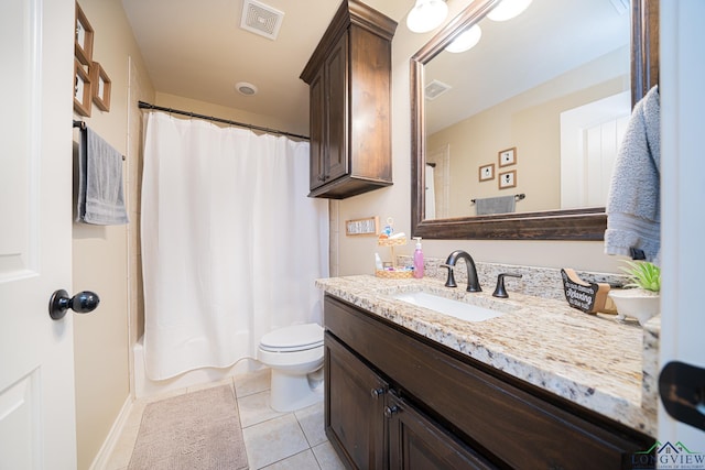 full bathroom featuring tile patterned floors, vanity, toilet, and shower / tub combo with curtain