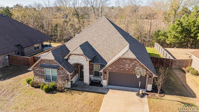 view of front of property featuring a front yard and a garage