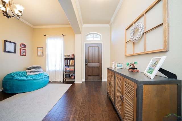 foyer entrance featuring a notable chandelier, dark hardwood / wood-style floors, and ornamental molding