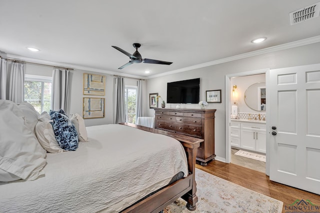 bedroom with visible vents, ornamental molding, and multiple windows