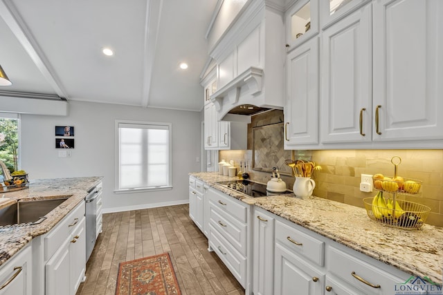 kitchen with white cabinets, backsplash, baseboards, and a sink