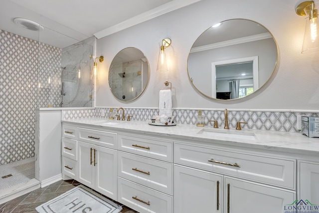 bathroom with tiled shower, a sink, and crown molding