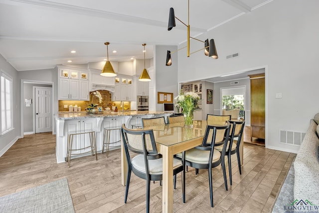 dining room with visible vents, light wood-style floors, and a healthy amount of sunlight
