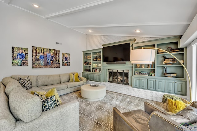 living area featuring vaulted ceiling with beams, visible vents, and a fireplace