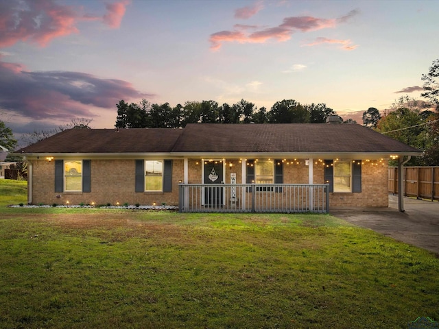 single story home featuring a lawn and a porch