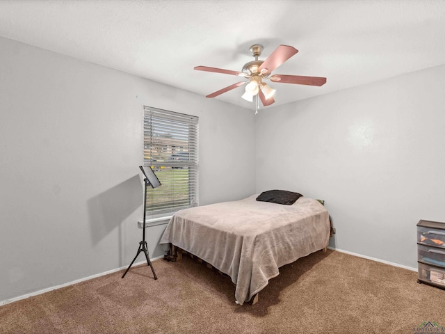 bedroom featuring ceiling fan and carpet