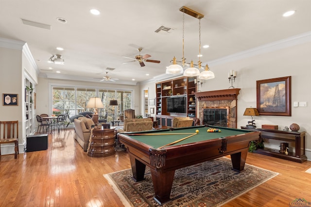 rec room with pool table, ornamental molding, and light hardwood / wood-style floors