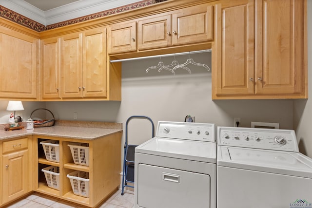 washroom featuring cabinets, light tile patterned floors, and washer and clothes dryer