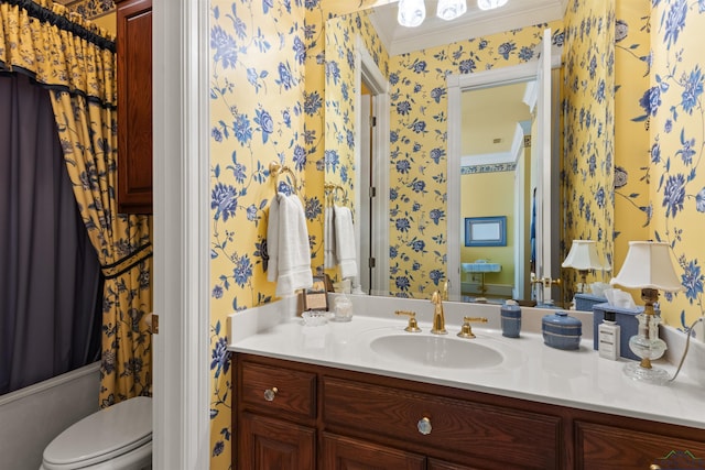 full bathroom featuring crown molding, vanity, toilet, and shower / bath combo with shower curtain