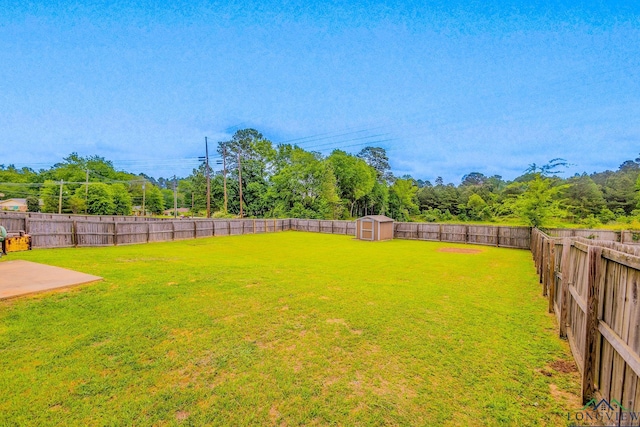 1202 Santa Cruz Dr, Longview, TX 75601 - view of yard featuring a fenced backyard, a storage unit, and an outdoor structure