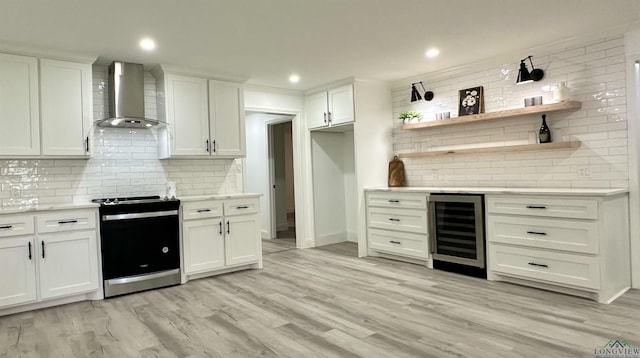 209 E Edgefield Ave, Longview, TX 75602 - kitchen featuring beverage cooler, stainless steel range oven, wall chimney exhaust hood, backsplash, and light countertops