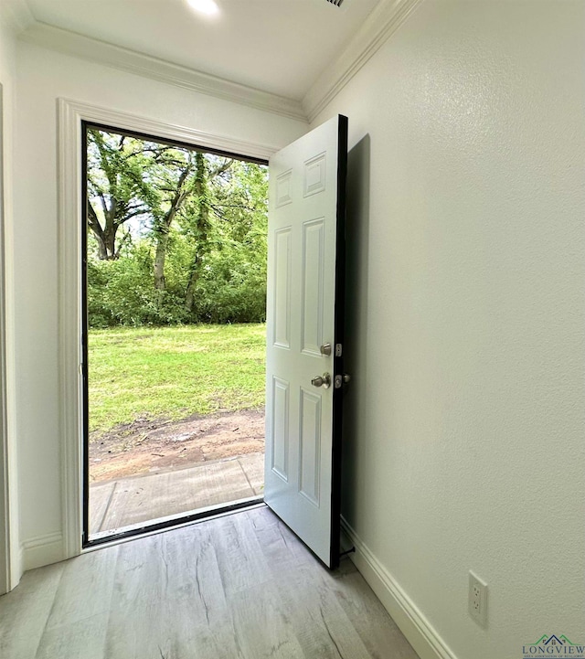 209 E Edgefield Ave, Longview, TX 75602 - doorway to outside featuring crown molding and light wood finished floors