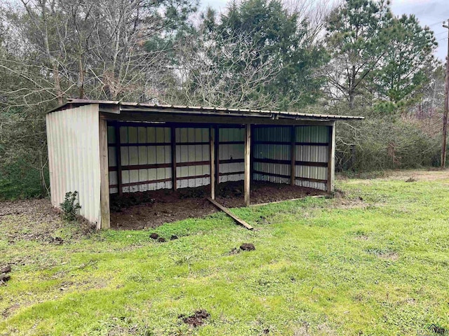 view of outbuilding featuring a lawn