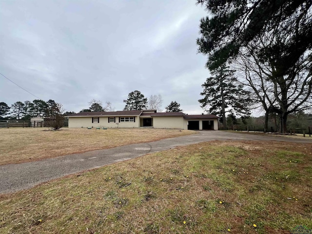 ranch-style house with a garage and a front yard