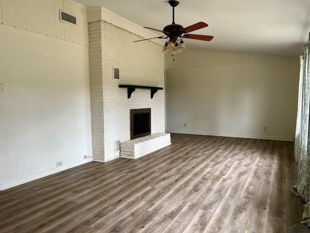 unfurnished living room with hardwood / wood-style flooring, vaulted ceiling, ceiling fan, and a fireplace