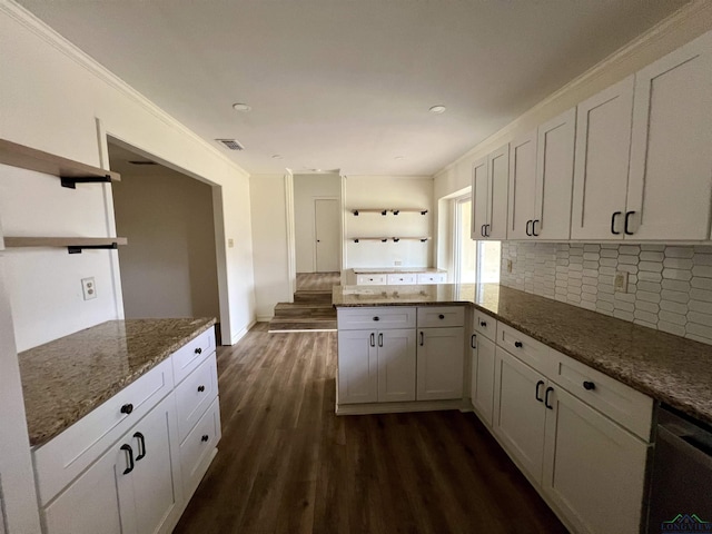 kitchen with dishwasher, tasteful backsplash, light stone countertops, white cabinets, and dark hardwood / wood-style flooring